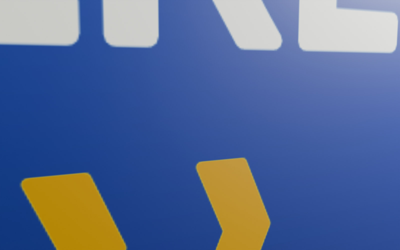 A printed panel insert from 24 cm without Print Realism: the foot of the white lettering HERE and two yellow chevrons on blue, a flat picture